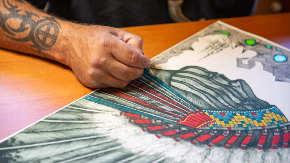 Evans Flammond Sr. (Oglala Sioux, Rosebud Sioux) | works on artwork at Yellowstone Tribal Heritage Center.